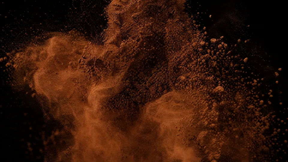 Fine cocoa powder in motion